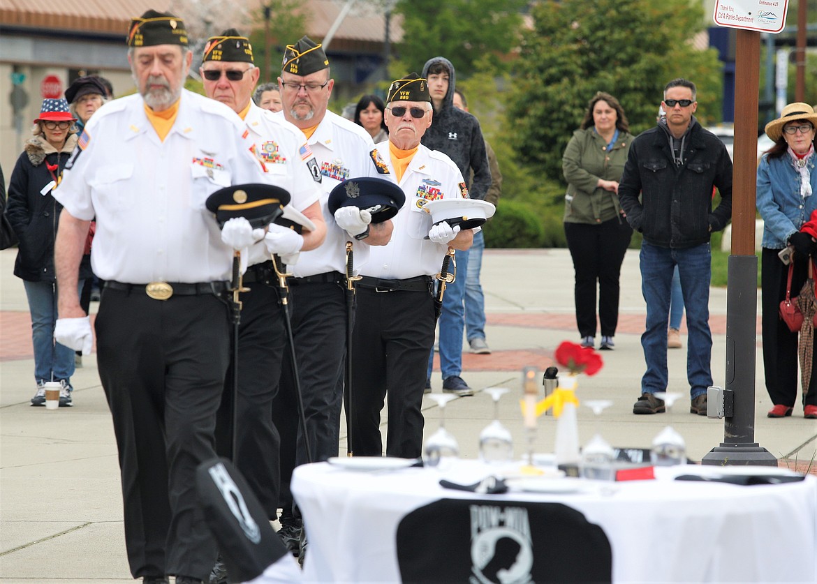 Veterans Richard Biggar, David Morgensen, Jeff Broadhead and Bob Martin carry out the Missing Man ceremony at McEuen Park Veterans Memorial Plaza on Monday.