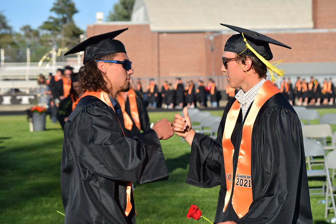 Ephrata High School graduates trade a fist bump during graduation in 2021. All local high schools have scheduled graduation ceremonies over the next two weekends.