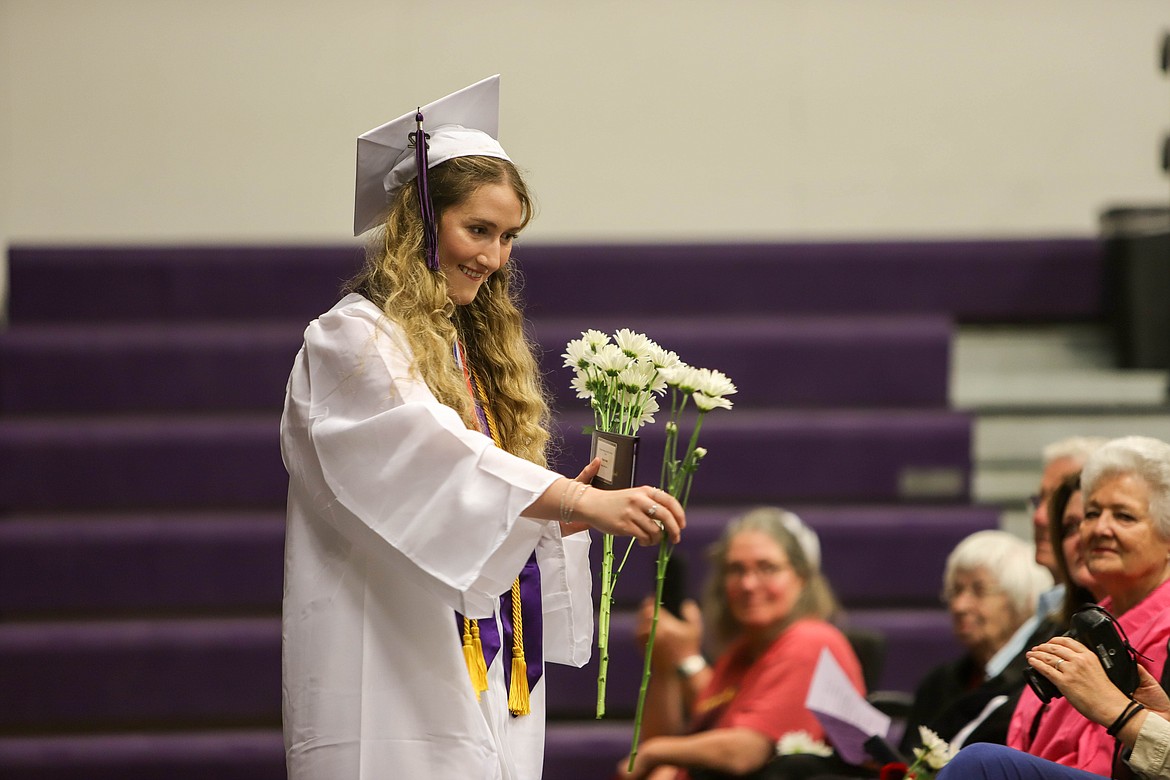 Molly Kate Sullivan givers her family flowers at the Charlo High School graduation on May 29, 2022. (JP Edge/Hungry Horse News)