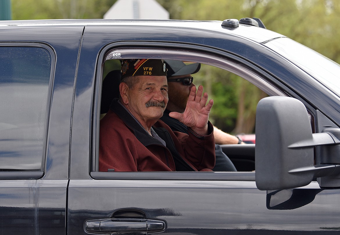 A veteran waves to the crowd during the Memorial Day Parade on Monday. (Whitney England/Whitefish Pilot)