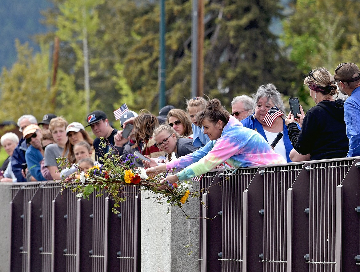 The Whitefish Memorial Day Parade pauses on the Veterans Memorial Bridge Monday afternoon for a wreath laying ceremony during which a wreath is dropped into the Whitefish River. (Whitney England/Whitefish Pilot)