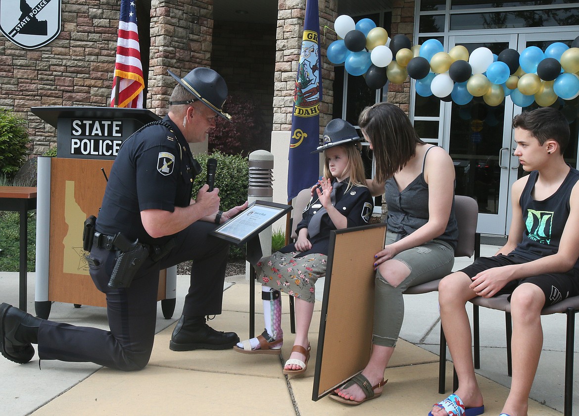 Idaho State Police Capt. John Kempf swears in honorary trooper Jaicey Lupton, 7, during a special ceremony Tuesday afternoon.