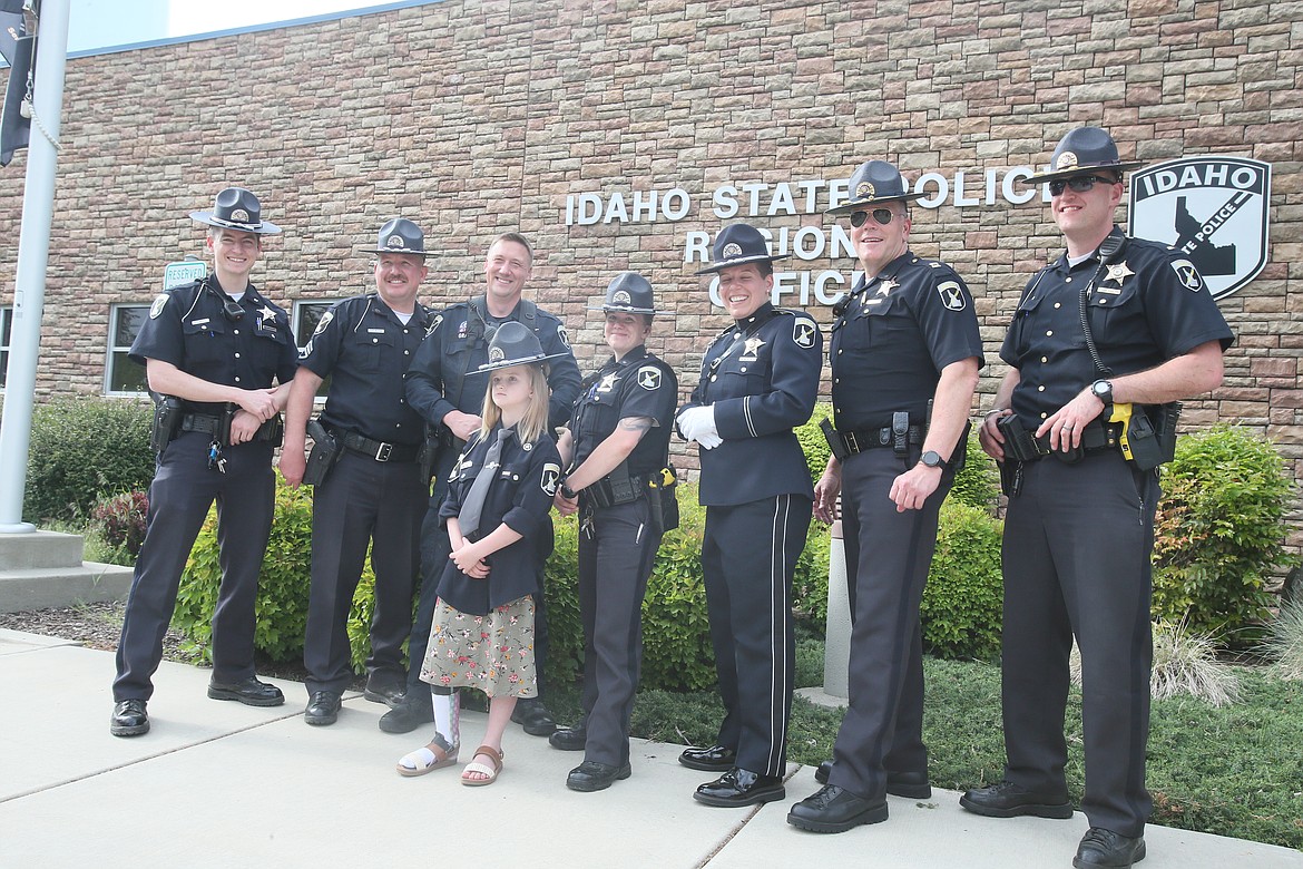 Honorary Idaho State Police Trooper Jaicey Lupton takes a serious police stance as she has photos taken with her new colleagues Tuesday. Jaicey, 7, has battled an undiagnosed terminal illness since she was 2. She has undergone countless procedures and is scheduled for two more brain surgeries later this month.