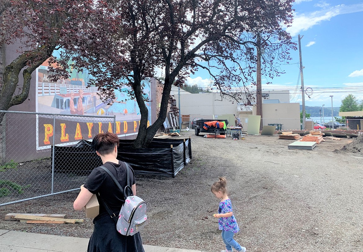 People pass by Sherman Square Park in downtown Coeur d'Alene on Tuesday. Park improvements are tentatively targeted completion this summer.
