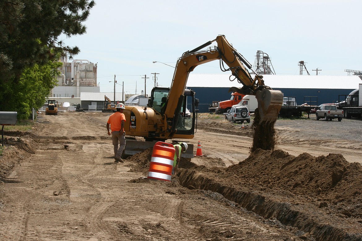 Construction workers dig a trench for electrical conduit on B Street Northeast in Quincy Wednesday morning. Six blocks of the street are being rebuilt.