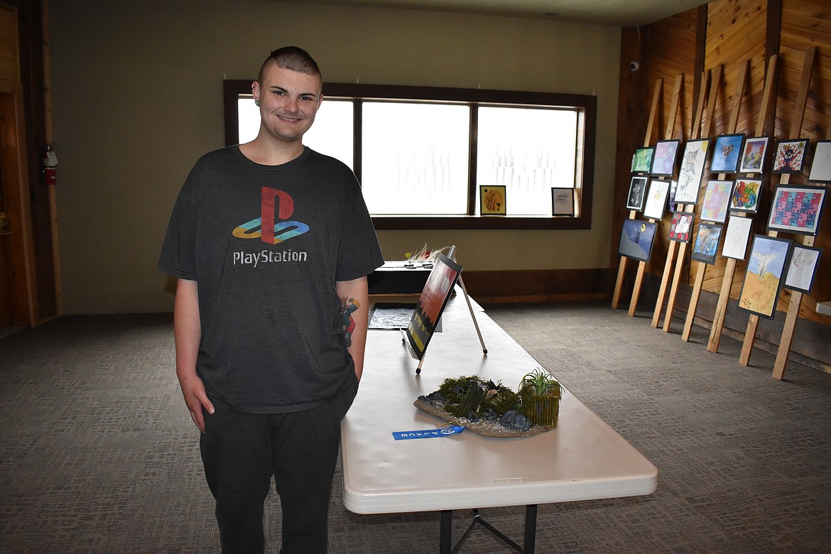 Jaeden stands in front of his forest diorama made completely out of recyclable material. He received a blue ribbon for his piece.