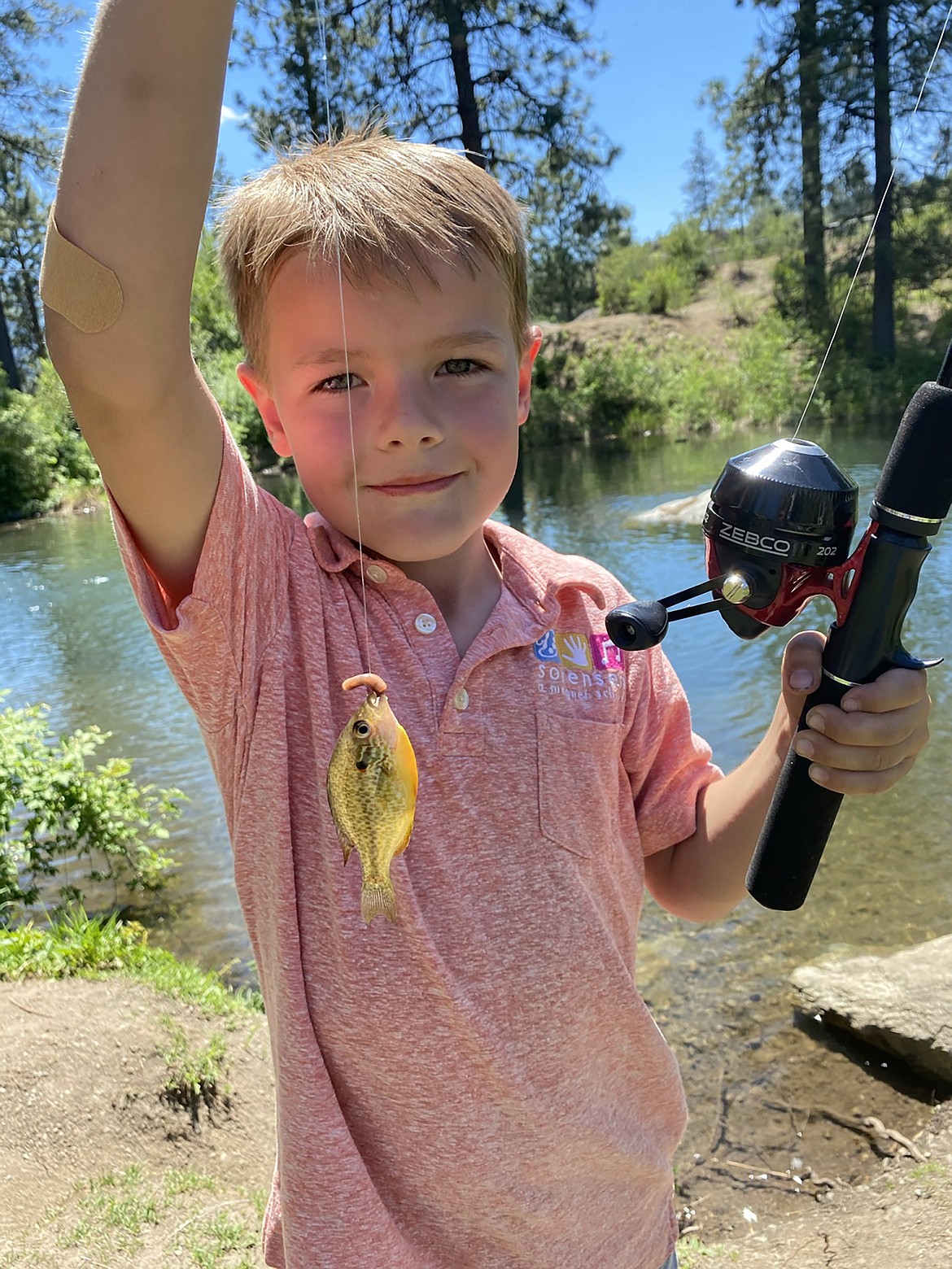 A young child shows off the fish he caught. Area waters were recently stocked with a variety of fish as fishing season gets underway.