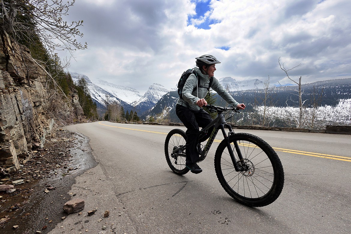 A visitor bikes her way up the Going to the Sun Road in Glacier National Park May 21, 2022. The park saw visitation drop of more than 16,000 in April. (Jeremy Weber/Daily Inter Lake)