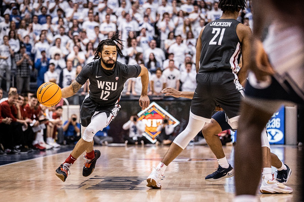 Cougar guard Michael Flowers (left) drives down to the basket while teammate Dishon Jackson (right) sets a screen in WSU’s win over BYU in the NIT.