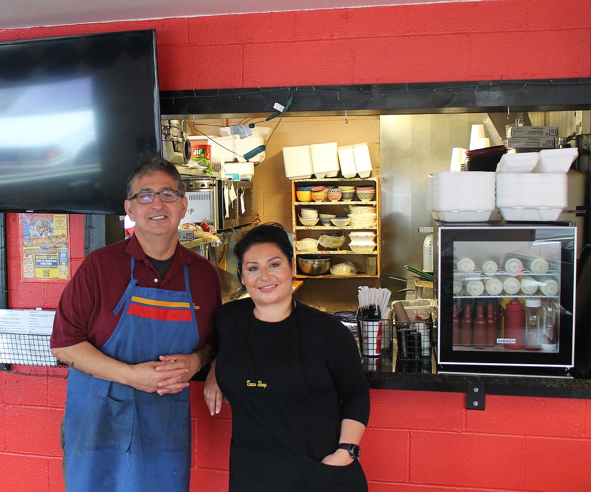 Taco Shop owner Pete Gonzalez, left, and his business partner Rae Anne Journey stand in front of the restaurant’s tiny kitchen. The Taco Shop celebrated its 45th anniversary last Wednesday.