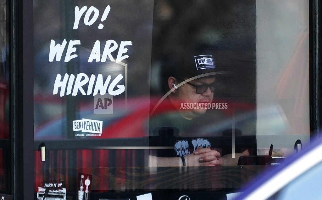 A hiring sign is displayed at a restaurant in Schaumburg, Ill., April 1, 2022. The white-hot demand for U.S. workers cooled a bit in April, though the number of unfilled jobs remains high and companies are still desperate to hire more people. Employers advertised 11.4 million jobs at the end of April, the Labor Department said Wednesday, June 1, 2022 down from nearly 11.9 million in March, the highest level on records that date back 20 years. (AP Photo/Nam Y. Huh, file)