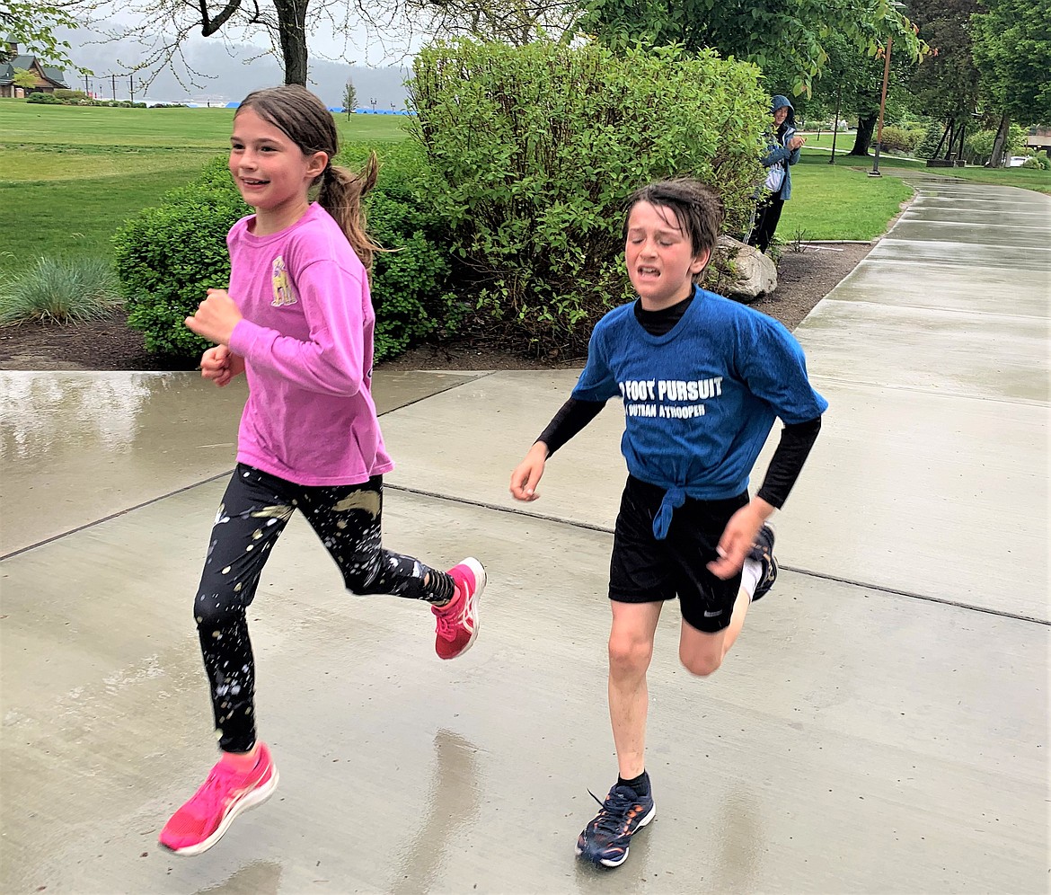 Shelby and Archer Alderson race to the finish line of the 5K Foot Pursuit on Saturday at McEuen Park.