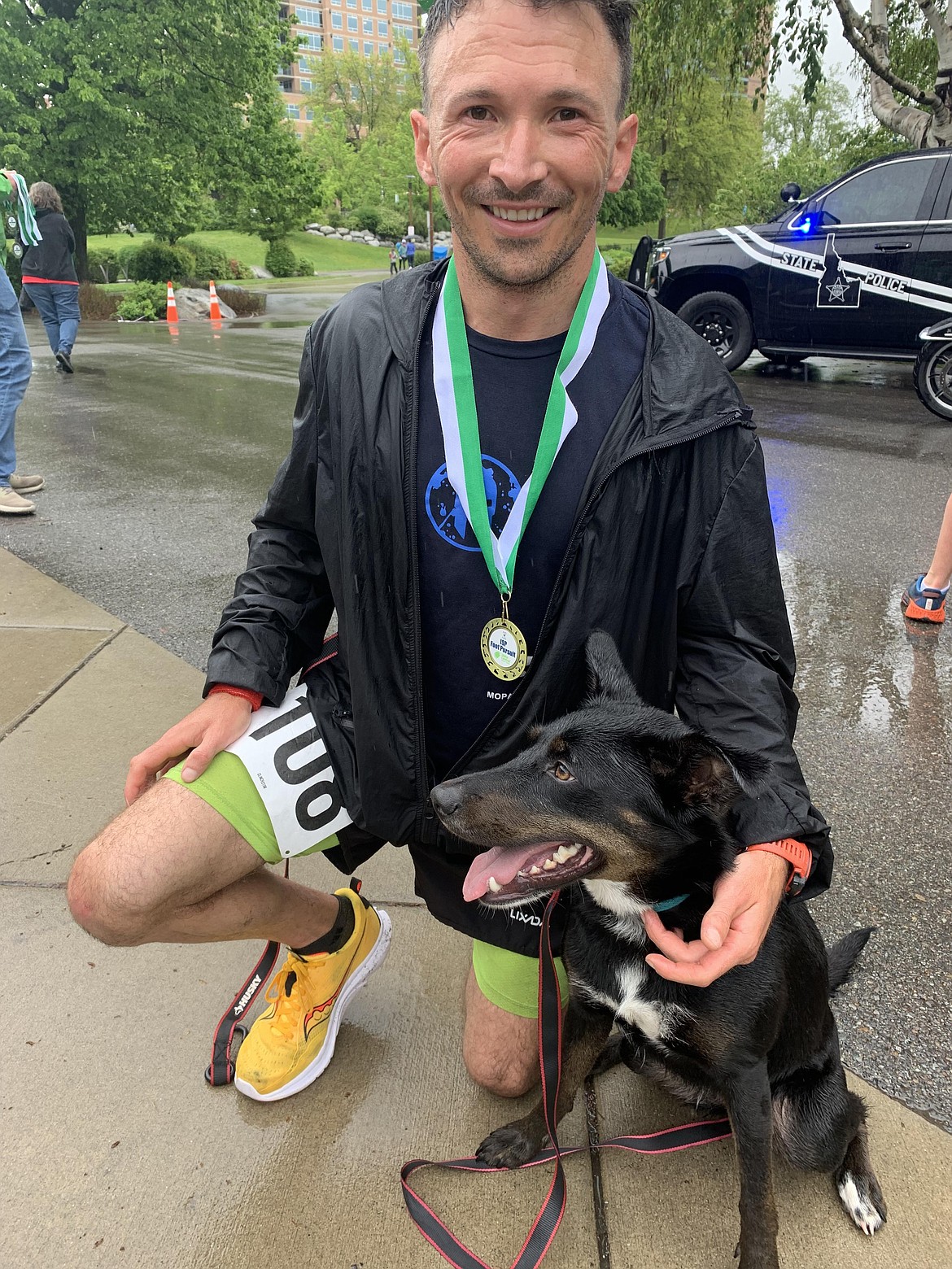 Scott Giltner of Hayden and his dog, Grace, relax after winning the 5K Foot Pursuit on Saturday at McEuen Park.