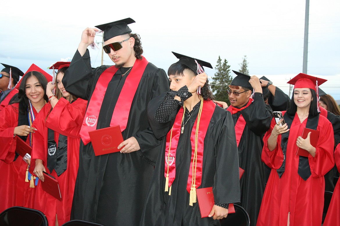 Othello seniors move the tassel to signify they’ve graduated during Friday’s ceremony at Huskie Stadium.