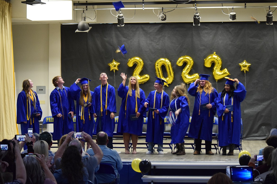 Wilson Creek High School graduates (left to right) Kesiah Cook, Davey McMillan, Ella True, Kass Newman, Rylee Jo Wilson, Taeven Brashear, Annika Mikel Tillson, Elijah Adamson and Madelayna Grajeda start to toss their caps at the school’s 2022 graduation ceremony on Saturday.