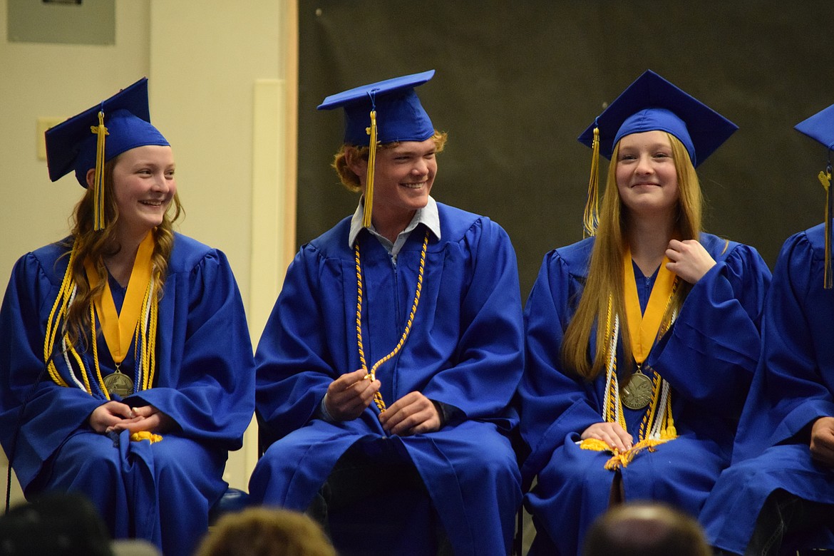 Wilson Creek High School graduating seniors Kesiah Cook, Davey McMillan and Ellah True during the school’s 2022 graduation ceremony on Saturday.