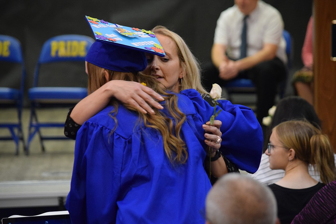 A Wilson Creek High School graduating senior thanks a family member during the school’s graduation ceremony on Saturday. Giving flowers to family members is a regular part of the tiny school’s graduation ceremony.