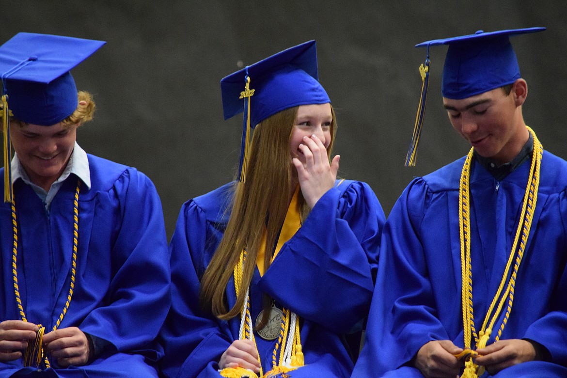 Wilson Creek High School graduating seniors Davey McMillan, Ella True and Kass Newman during the school’s graduation ceremony on Saturday.