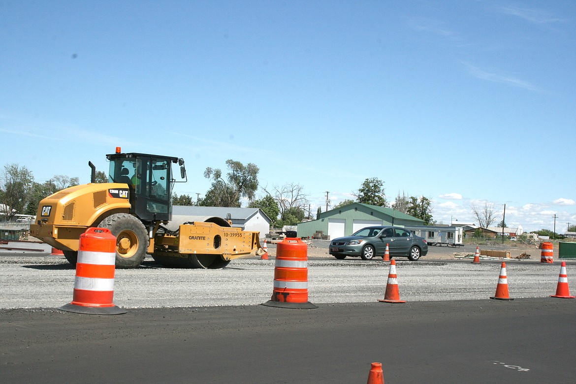 A compactor works the intersection at Grape Drive and state Route 17. One is open in each direction on SR-17, a traffic revision that should remain in place until early July.