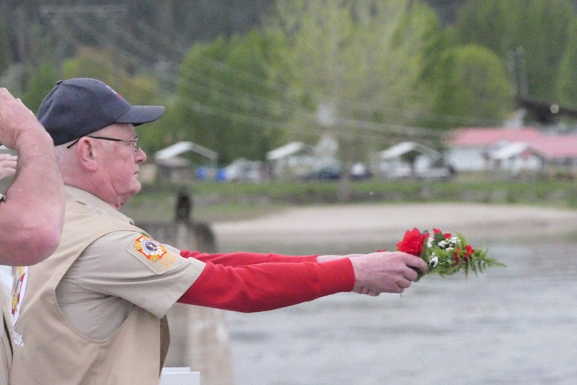 Navy veteran and Horse Plains VFW Chaplain Otto Otness holds a flowered wreath above the Clark Fork River prior to releasing it into the river below the Fairgrounds Bridge during Memorial Day ceremonies this past Monday.  (Chuck Bandel/VP-MI)