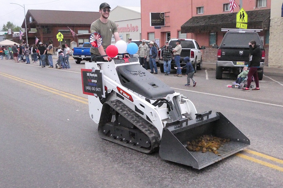 The clean-up crew, a Bobcat with a front-end loader attachment, brings up the rear after the Plains Days parade. (Chuck Bandel/VP-MI)