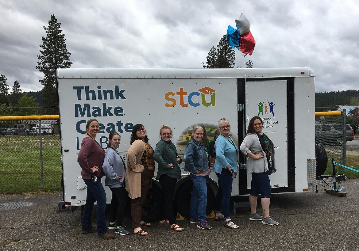 Pinehurst After-School Solution staff pose in front of the Think, Make, Create Lab.