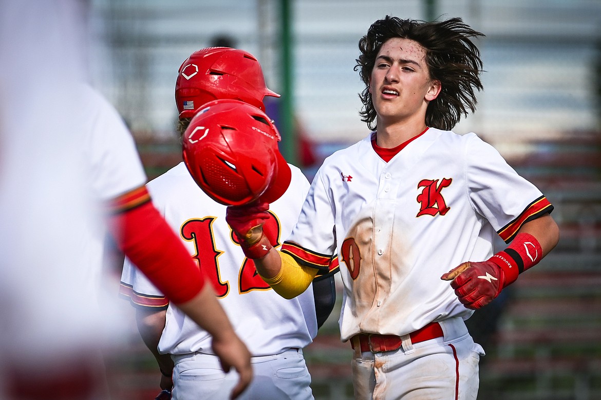Kalispell Lakers AA's Ostyn Brennan (10) is congratulated after scoring on a sacrifice fly by Max Holden in the first inning against the Missoula Mavericks at Griffin Field on Tuesday, June 7. (Casey Kreider/Daily Inter Lake)