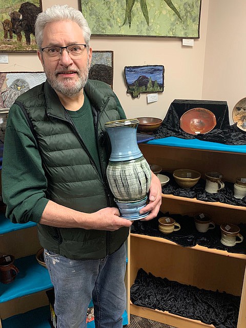Potter Bob Cass with his work at the Paint, Metal and Mud Gallery.