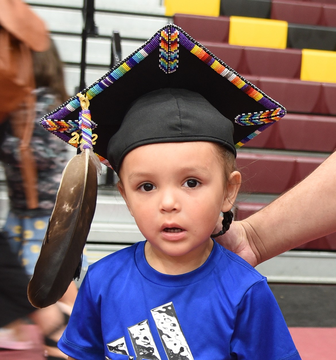 Lakaius Croff dons his father's beaded mortar board. Jalen Croff graduated with a Bachelor of Arts in Business Administration. (Marla Hall photo)