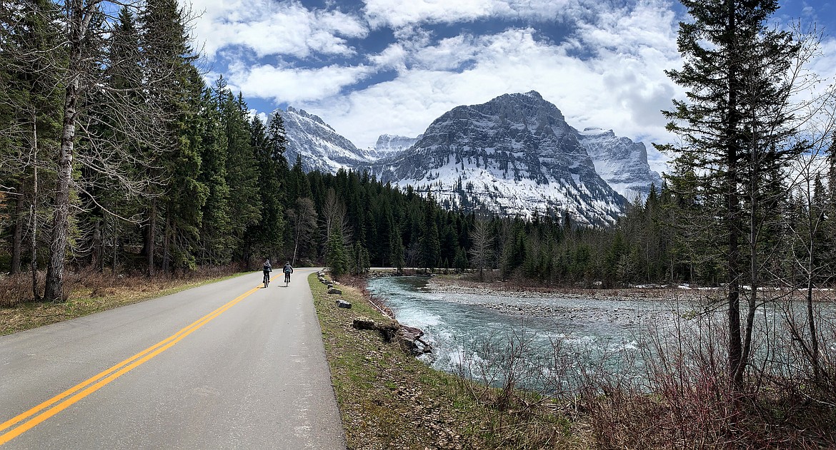 Cyclists make their way along McDonald Creek beneath Mt. Oberlin on the Going to the Sun Road in Glacier National Park Saturday, May 21, 2022. (Jeremy Weber/Daily Inter Lake)