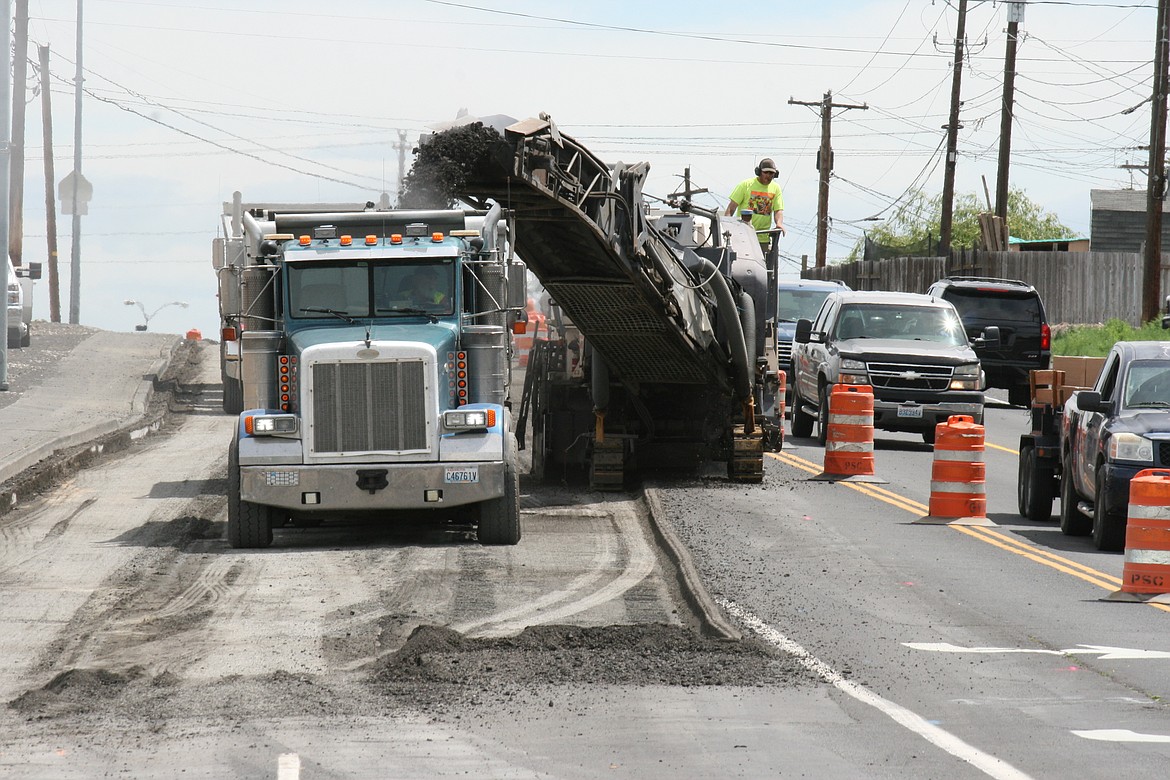 A milling machine removes the asphalt in the left turn lane at the intersection of Valley Road and Central Drive.