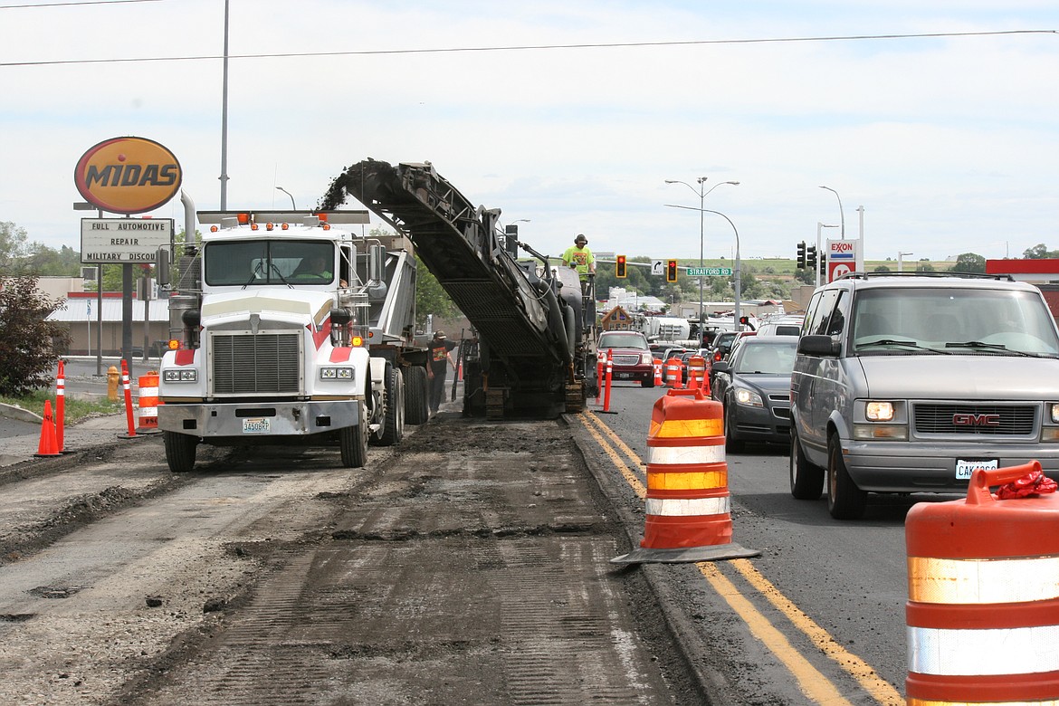 Cars work their way up Valley Road while construction crews remove asphalt, the first step in the repavement project.