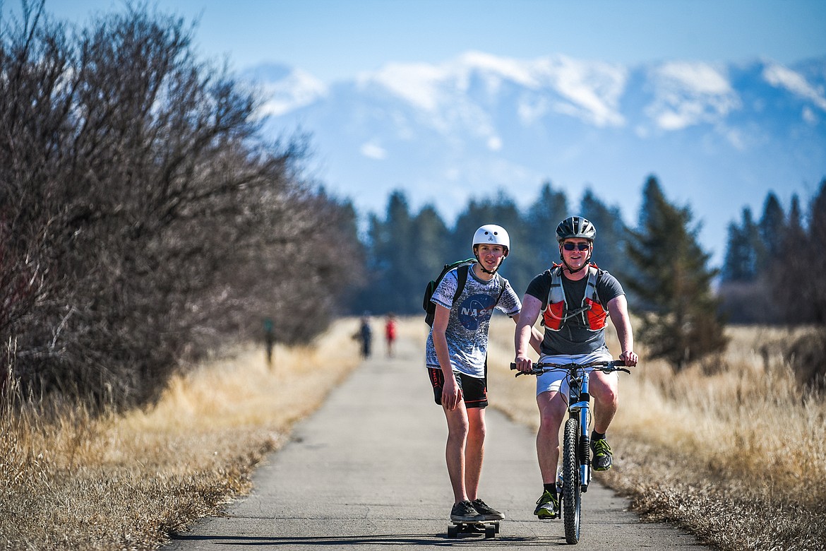 Connor and Aiden Zumalt, from Columbia Falls, enjoy a ride along the Great Northern Historical Trail in Kalispell on Saturday, March 13, 2021. (Casey Kreider/Daily Inter Lake)