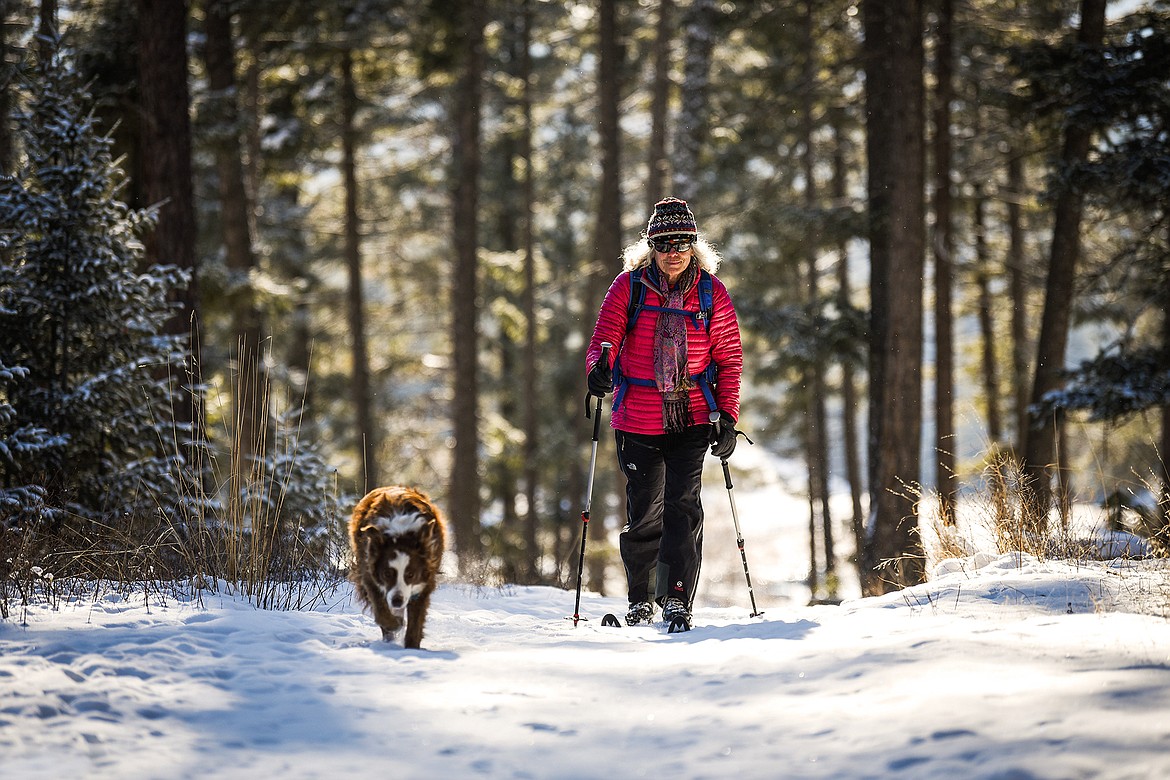 Becky Petrashek, of Kalispell, cross-country skis with her Australian shepherd named Breeze at Herron Park on the Foys to Blacktail trails on Tuesday, Feb. 9, 2021. (Casey Kreider/Daily Inter Lake)