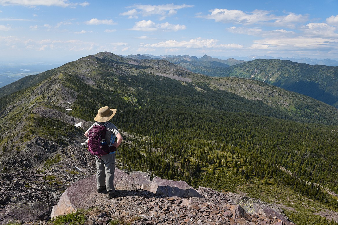 A hiker looks north along the Swan Crest from the summit of Sixmile Peak in Flathead National Forest on July 7, 2019. (Casey Kreider/Daily Inter Lake)