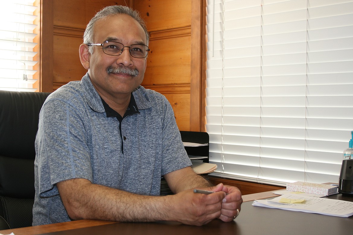 Serve Quincy Valley director Daniel Castillo at his desk in the organization’s office.