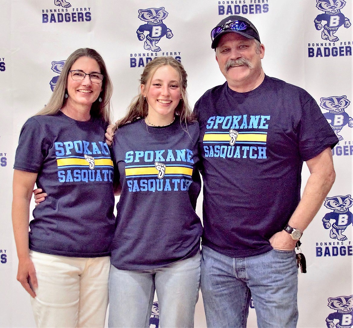 (center) Camille Ussher with her parents Alethia and Steve Ussher. She will run cross country and track at Spokane Falls Community College.