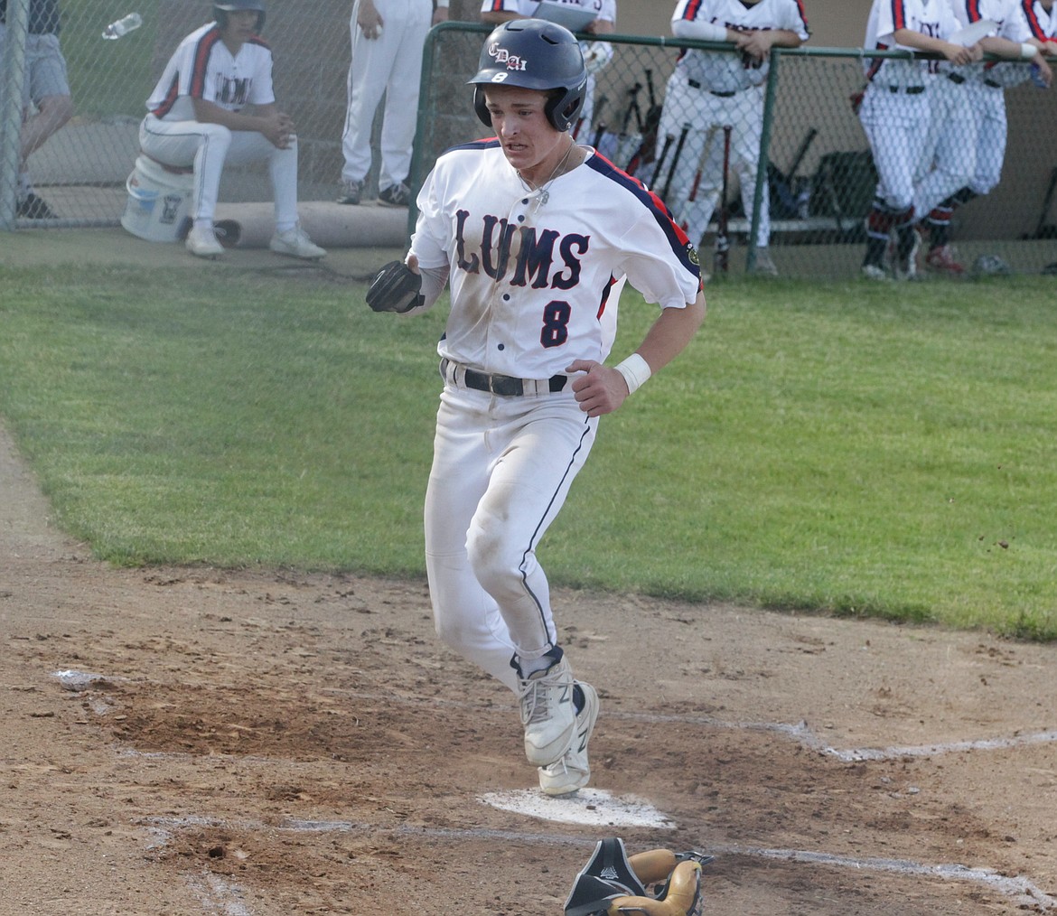 JASON ELLIOTT/Press
Coeur d'Alene Lumbermen left fielder Kyle Bridge races home to score on a sacrifice fly during the first inning of the first game of a doubleheader against the Spokane Expos on Wednesday at Thorco Field.