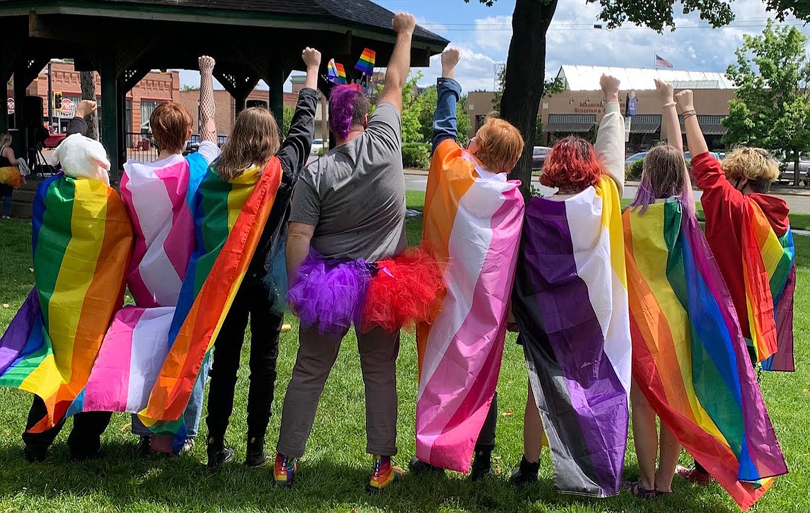 People stand with pride flags at Depot Park in Kalispell during Glacier Queer Alliance’s Pride Festival last year. (Courtesy photo)