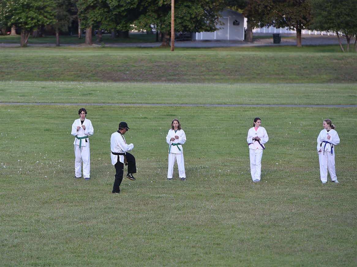 Libby Dae Myung Martial Arts Academy instructor Dan Rose teaches his young pupils a move Tuesday evening during a practice session at the Libby Elementary School. The academy celebrated its 40th anniversary this year. Rose, who has been involved with it for 27 years, said classes will end in June before resuming in the fall. (Scott Shindledecker/The Western News)