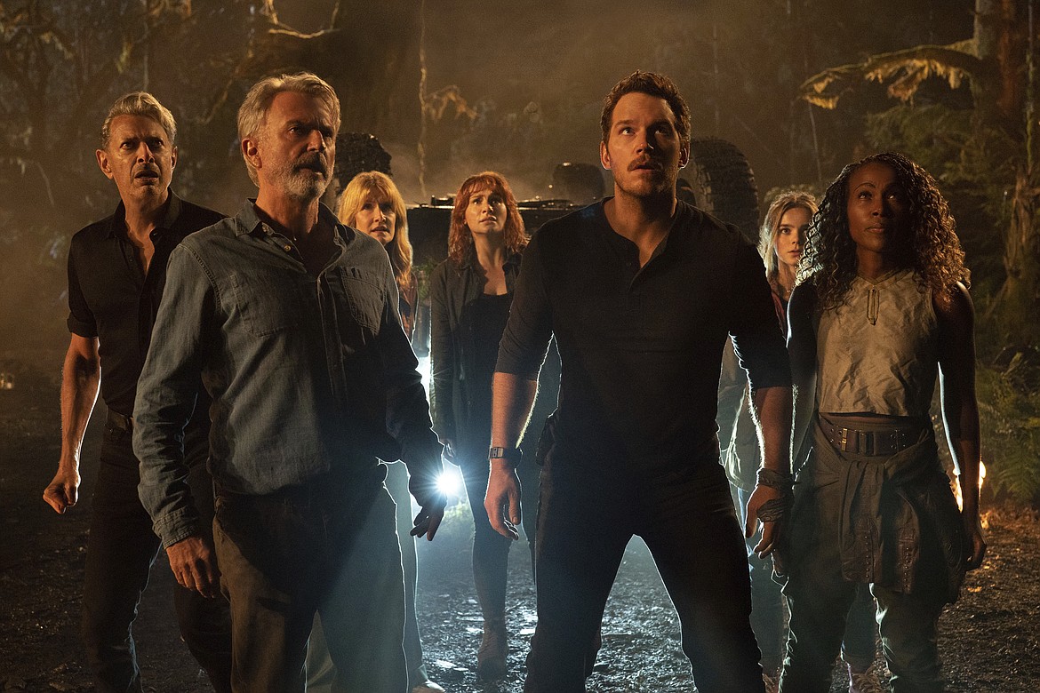 This image released by Universal Pictures shows, from left, Jeff Goldblum, Sam Neill, Laura Dern, Bryce Dallas Howard, Chris Pratt, Isabella Sermon and DeWanda Wise in a scene from “Jurassic World Dominion.” (Universal Pictures and Amblin Entertainment via AP)