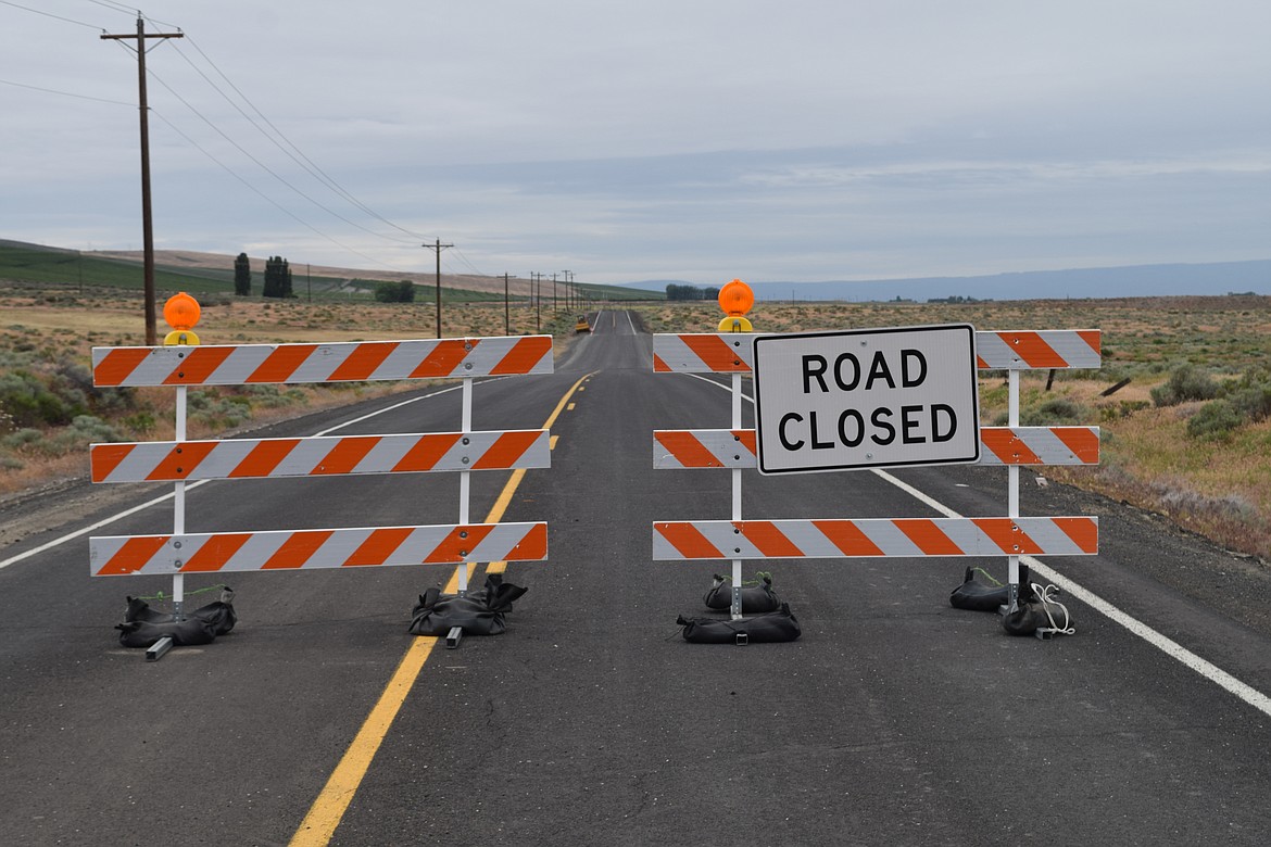 A mostly rebuilt section of Frenchman Hills Road near Road G.5 SW behind the “Road Closed” barricades that had been washed away when a canal operated by the Quincy Columbia Basin Irrigation District was breached in several places in the early hours of Friday, March 21. The work to rebuild the road has cost the county roughly $325,000, according to Public Works Director Sam Castro.