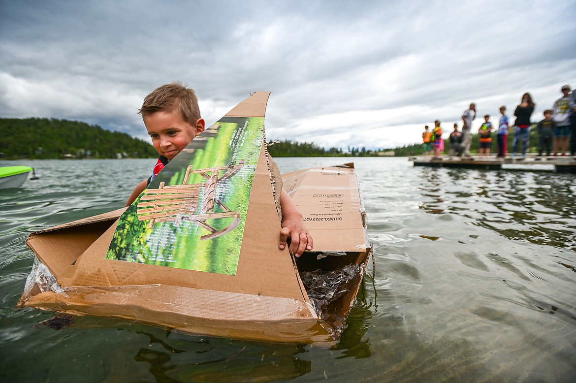 St. Matthew's School first-grader Victor Gomes paddles his homemade cardboard boat around Foy's Lake on Friday, June 10. As part of St. Matthew's Jump Into Summer Science Program hosted by teacher Susie Rainwater, 47 students in grades 1-5 used applied science and math concepts to construct their crafts and test their buoyancy in the waters of Foy's Lake. (Casey Kreider/Daily Inter Lake)