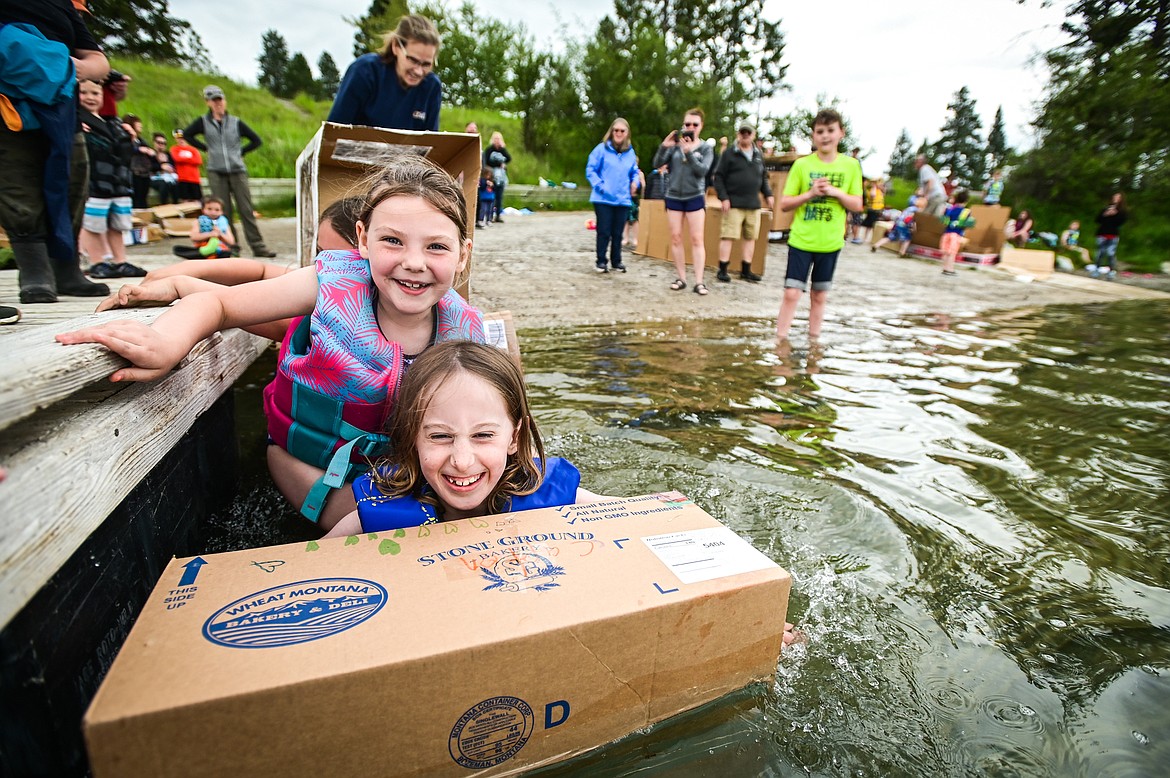 St. Matthew's School students Charlotte Barber and Madison Straus launch their homemade cardboard boat into Foy's Lake on Friday, June 10. As part of St. Matthew's Jump Into Summer Science Program hosted by teacher Susie Rainwater, 47 students in grades 1-5 used applied science and math concepts to construct their crafts and test their buoyancy in the waters of Foy's Lake. (Casey Kreider/Daily Inter Lake)