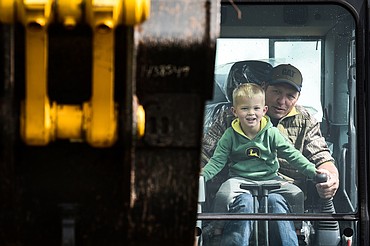 Cannon Dunn, 3, works inside an excavator with Bruce Roberts at the DIG Rotary event held by Kalispell Daybreak and Noon Rotary Clubs and LHC at the Kalispell North Town Center on Highway 93 and Rose Crossing on Saturday, June 11. Attendees got the opportunity to operate excavators, bulldozers and graders with proceeds going toward the creation of a Splash Pad full of sprayers, showers and water features along the Kalispell Parkline Trail. (Casey Kreider/Daily Inter Lake)