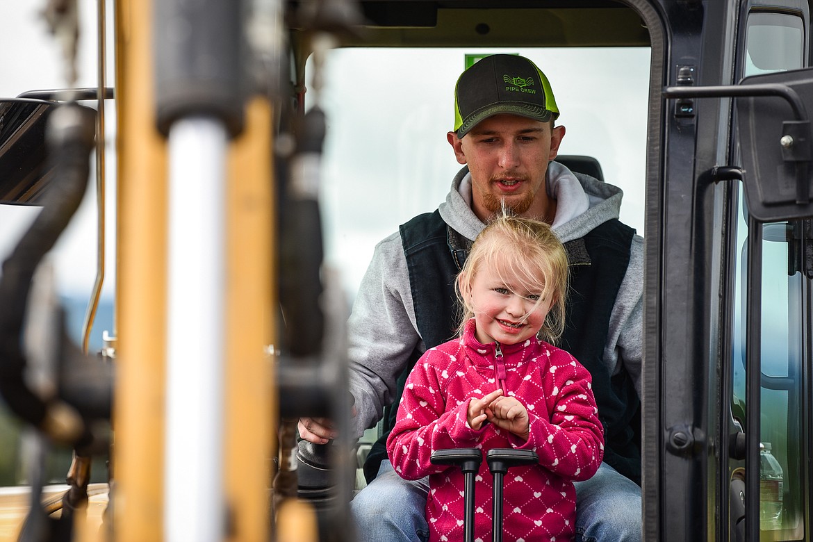 Kailin Reddig, 4, works inside an excavator with Dylan Sahota at the DIG Rotary event held by Kalispell Daybreak and Noon Rotary Clubs and LHC at the Kalispell North Town Center on Highway 93 and Rose Crossing on Saturday, June 11. Attendees got the opportunity to operate excavators, bulldozers and graders with proceeds going toward the creation of a Splash Pad full of sprayers, showers and water features along the Kalispell Parkline Trail. (Casey Kreider/Daily Inter Lake)