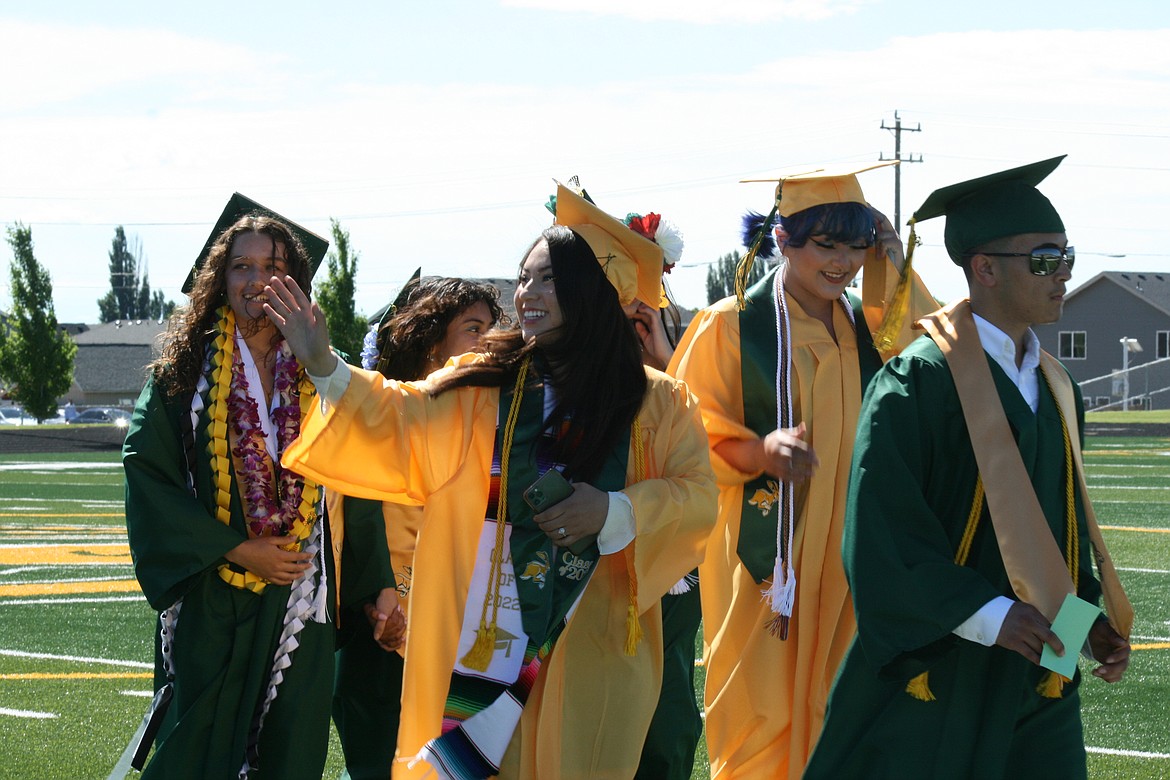 It’s part of the tradition at Quincy High school graduation for the class to enter along the track, and the tradition within the tradition is to wave to family and friends in the crowd.