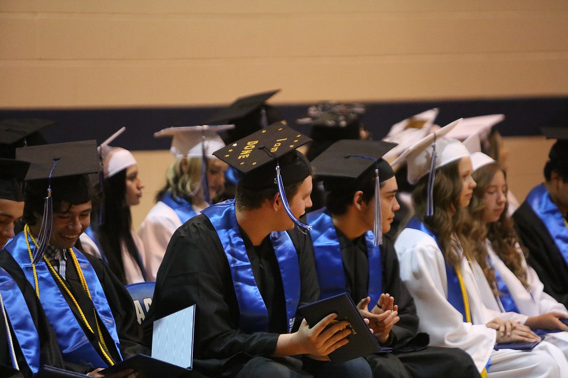 “I am done,” reads the decorated cap of a graduate during the ceremony at Soap Lake High School.