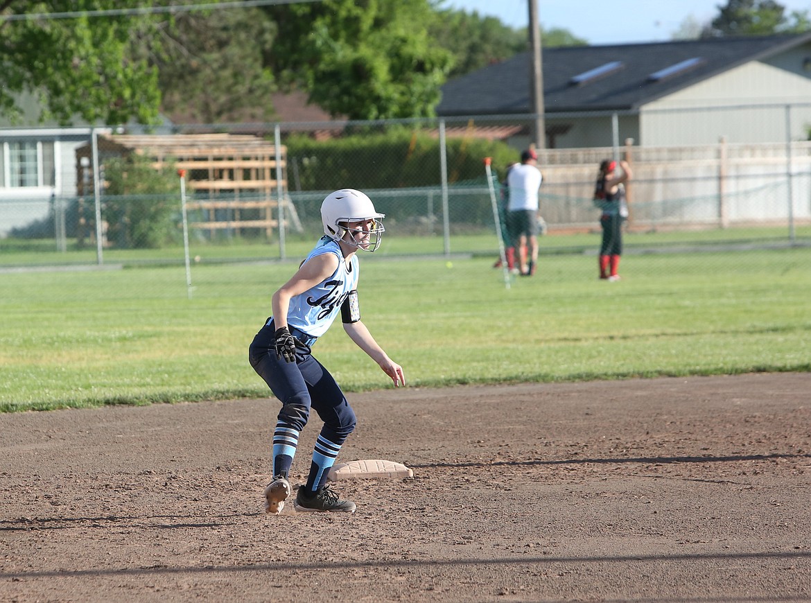 A Yakima Tigers player waits on second base before stealing third on a wild pitch.