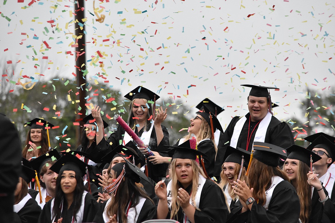 Graduates set off confetti cannons in honor of their classmate, Billy Rhodes, who could not attend graduation because he was receiving treatment for cancer.